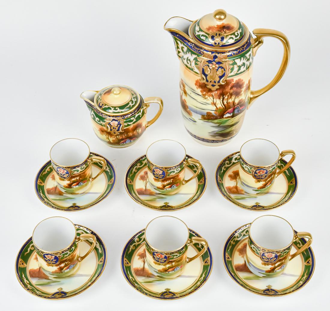 Noritake Scenic Tea Set: Includes teapot, 6 cups & saucers, and creamer. All with nice gold work, on green and blue background. M within wreath backstamp. Teapot 9 1/4" high. Good condition.