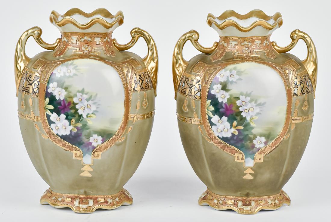 Pair of Nippon Gold & Floral Decorated Vases: Beautiful Pair of double handled vases, each with a hand painted floral center, surrounded by beads and gold decoration. Both with M within wreath backstamp. Fine condition. 8 1/4" High.