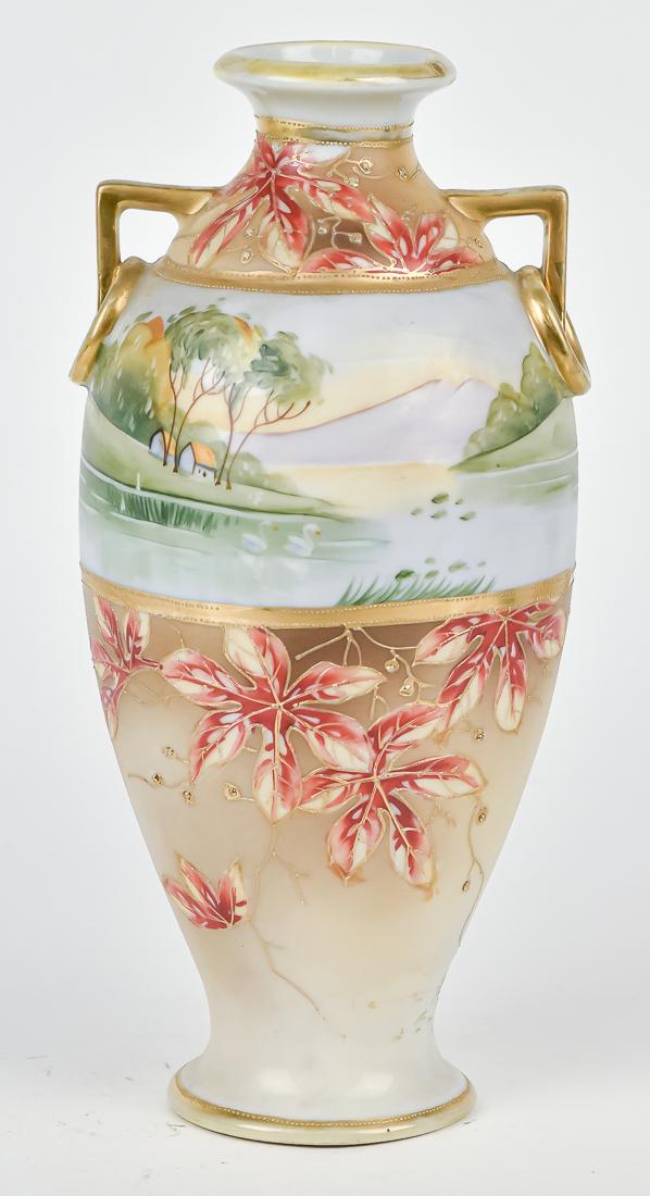 Nippon Scenic Vase with Lake Scene: Fine double handled vase with lake scene, with swans all surrounded by maple leaves and gold decoration. Maple leaf Nippon backstamp. 11 1/2" High. Good condition.