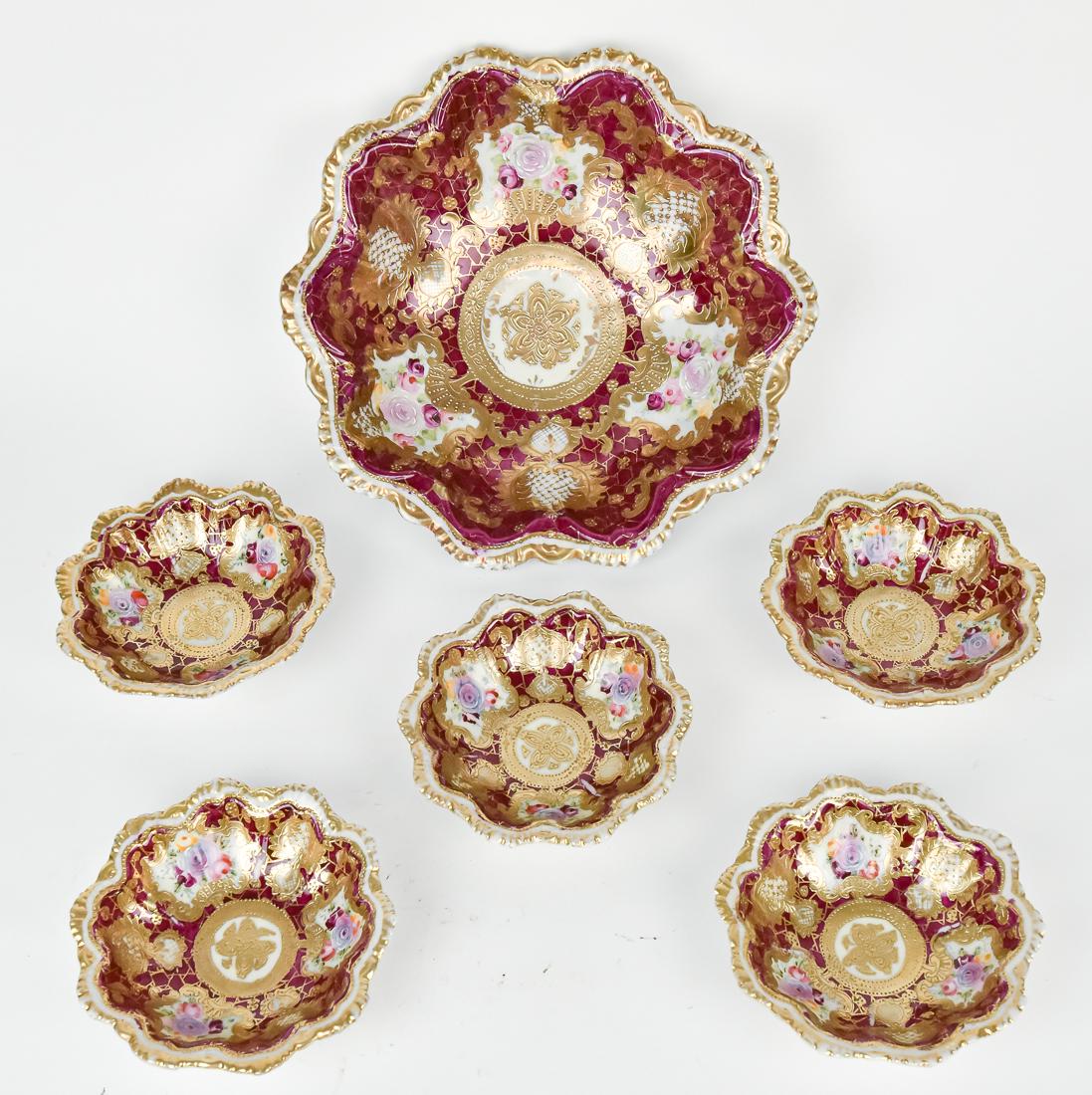 Nippon Highly Gold Decorated Berry Bowl Set: With floral decoration on maroon background. Japanese character backstamp. 11" Diameter. All in good condition.