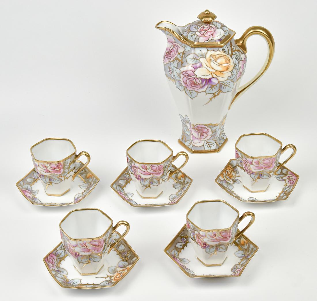 Nippon Chocolate Set: Hand painted florals, with pronounced gold decoration. 10" chocolate pot with five cups & saucers. Maple leaf Nippon backstamp. Good Condition.