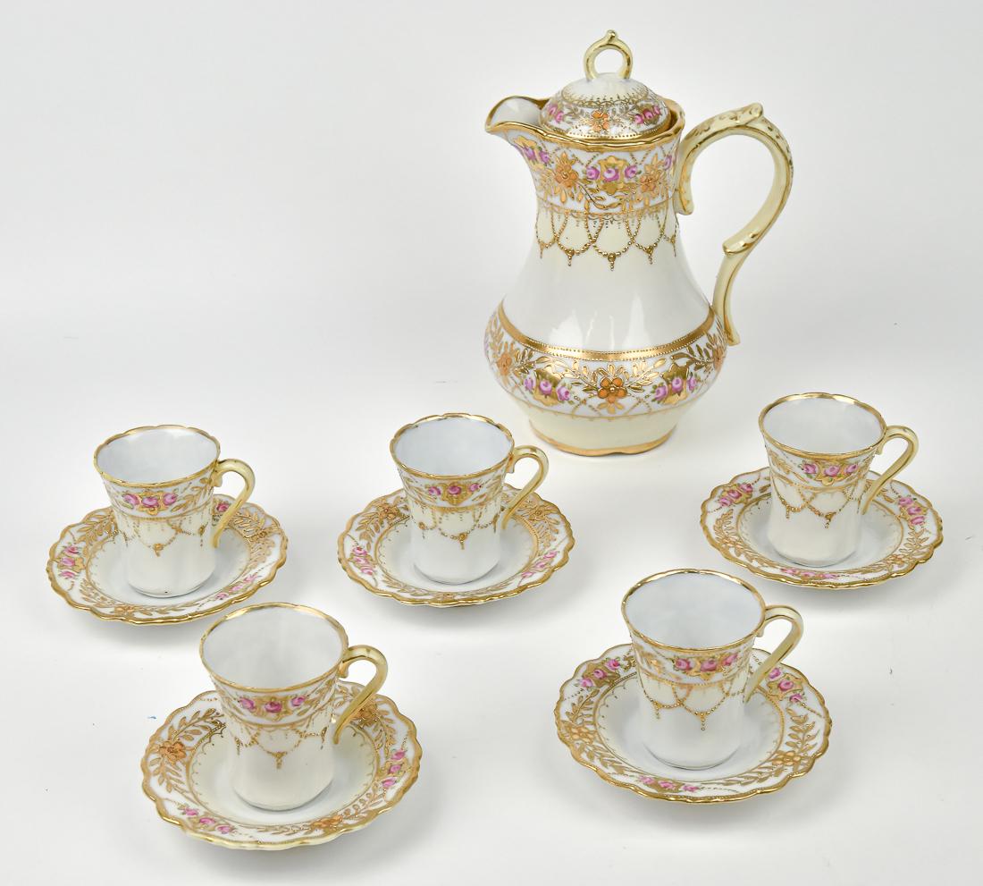 Nippon Chocolate Set: Lovely set, all with gold and beaded decoration over hand painted roses. 9 3/4" Chocolate pot with five cups and saucers, with maple leaf Nippon backstamp. All in good condition.