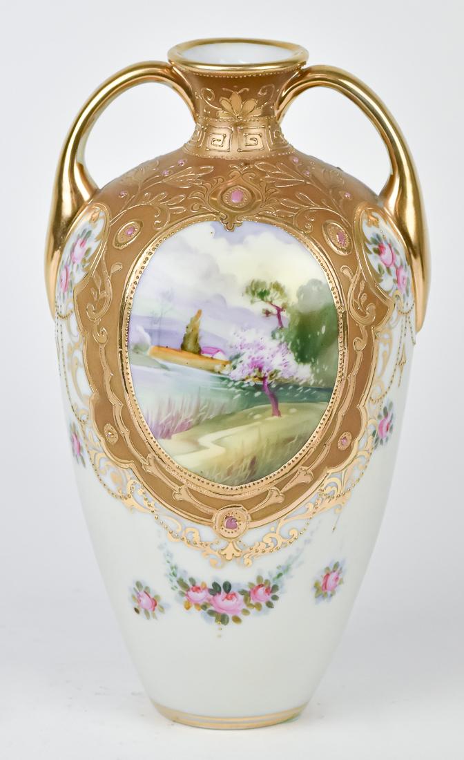 Nippon Scenic Double Handled Vase: Hand painted oval scene with stream surrounded by beaded jewels and gold decoration. Blue M within wreath backstamp, 9" High. Good condition.