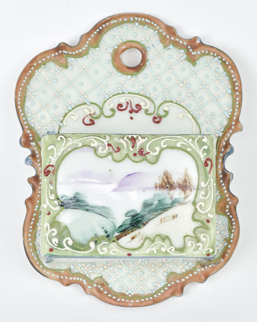Nippon Match Holder with Moriage Decoration: Scenic Front surround by moriage decoration, with striker on the side. Maple leaf Nippon backstamp. 5" High, good condition.