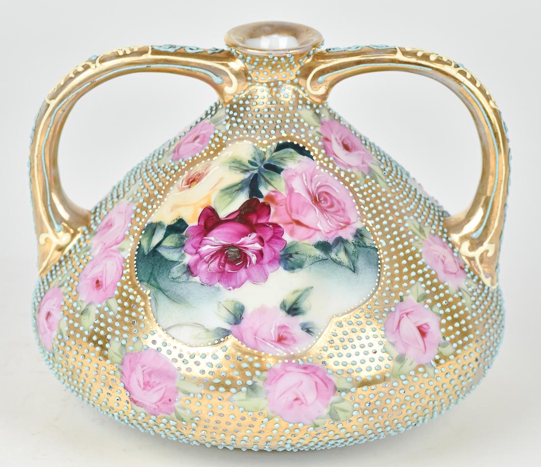 Nippon Double Handled Vase: With hand painted roses surrounded by gold and heavy enamel bead decoration. 5" High X 5 1/2" Wide. Royal Nippon backstamp. Good condition.