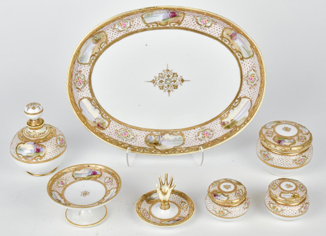 Super Seven Piece Nippon Dresser Set: All matching, including cologne bottle, 3 dresser jars, pedestal dish, ring holder, & tray. All with scenic panels surrounded by enameled jewels, and beaded gold decoration.Nippon era backstamp. Good