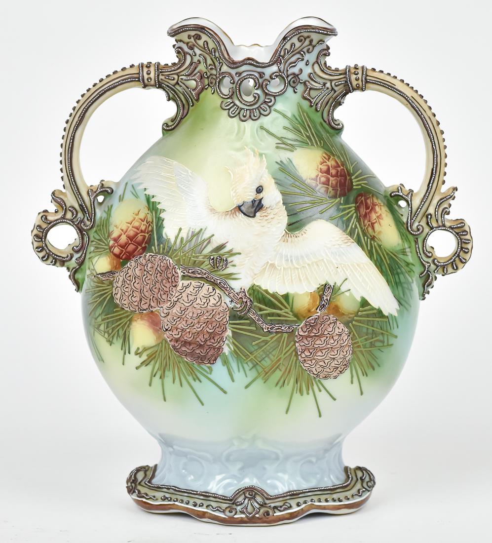 Rare Nippon Moriage Vase with Cockatoo: Double handled with lovely moriage work at handles and base. Moriage pine cones. Maple leaf backstamp. 9 3/4" high. Very minor loss of enamel at handles, otherwise good condition.