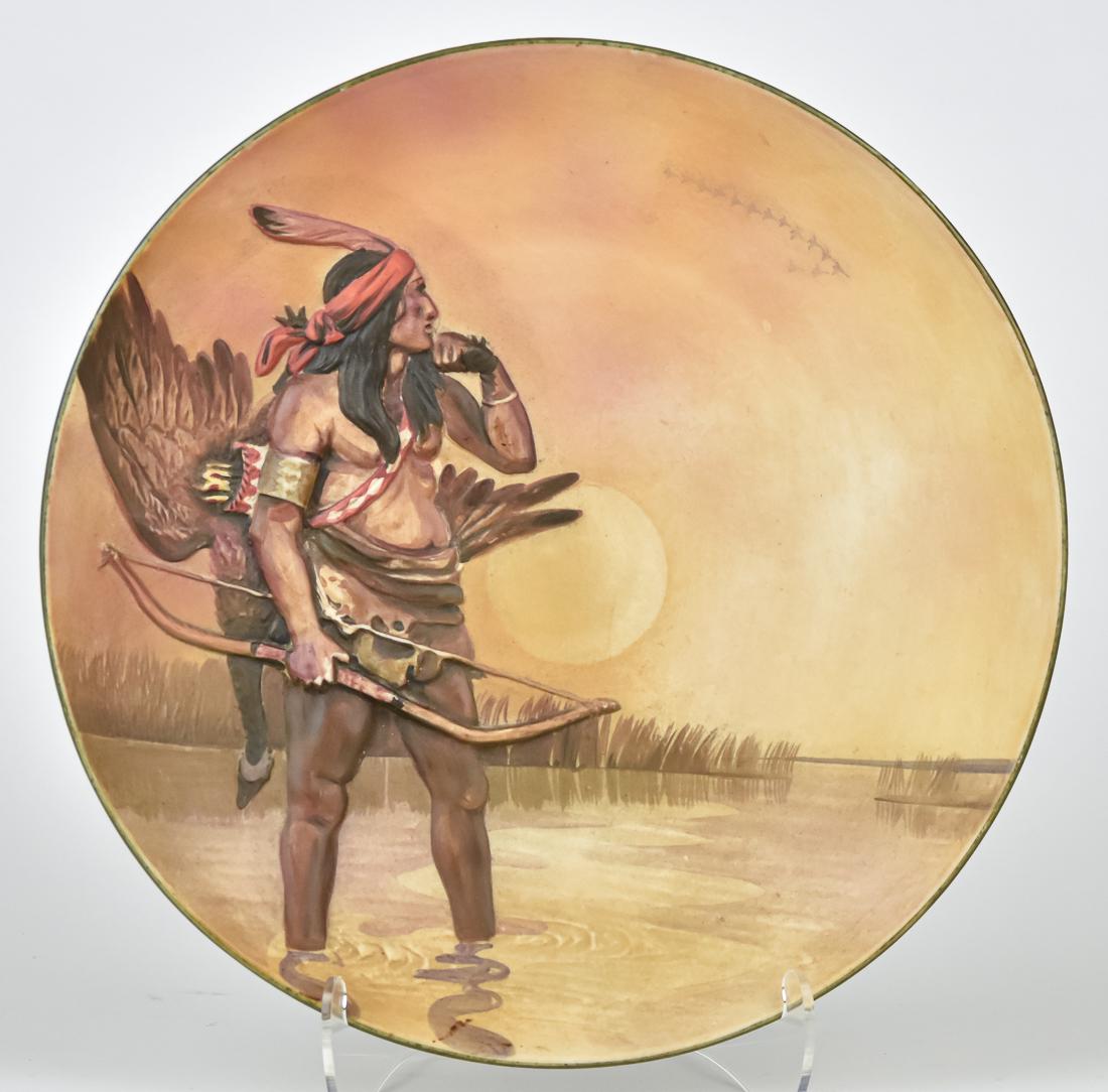 Nippon Indian Molded in Relief Plaque: Indian warrior with his hunted game on his back. M within wreath backstamp. 10 1/2" diameter. Good condition.