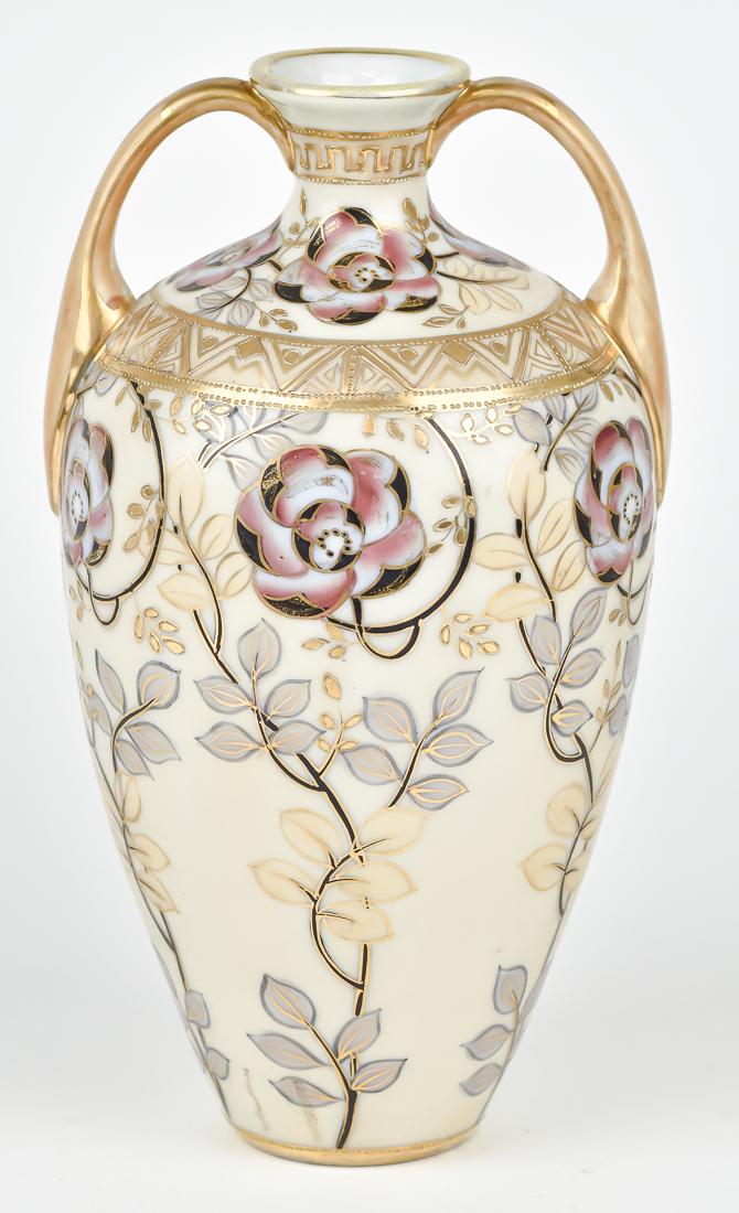 Nippon Double Handled Vase: Floral decoration with gold highlights. M within wreath backstamp. 9 1/4" high. Good condition.