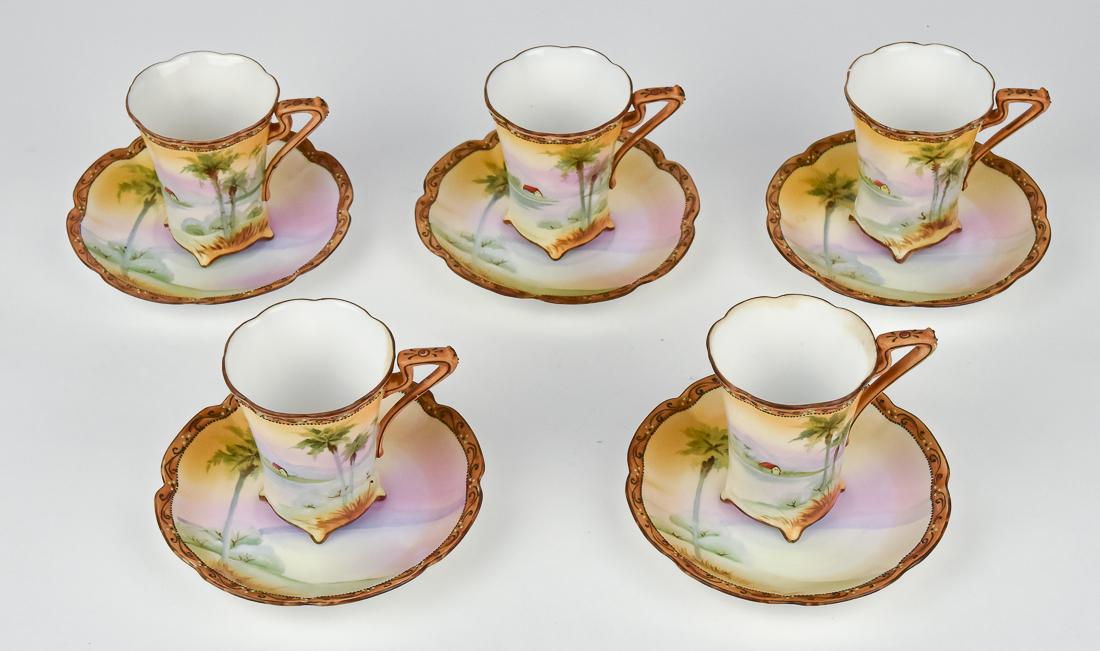 Five Nippon Scenic Cups & Saucers: Five footed chocolate cups & saucers. Maple leaf backstamp. Cups, 3 1/4" high. Good condition.