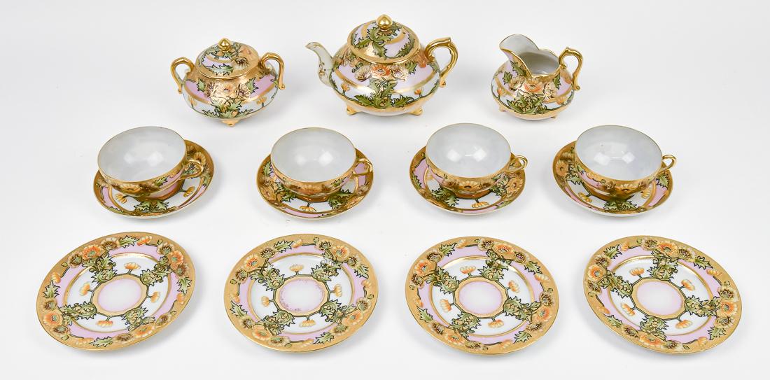 Nippon Footed Tea Set with Gold Beadwork: Includes teapot, creamer & sugar, four cups and saucers and four small plates. Magoya Nippon mark. Teapot 5 1/2" x 7 1/2". Good condition.
