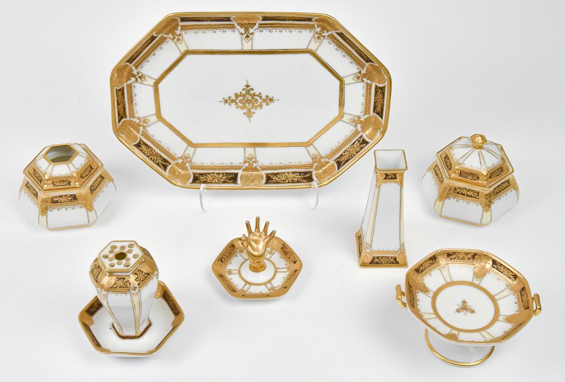 Nippon 7 Piece Dresser Set with Fine Gold Work: Includes 2 hatpin holders, ring tree, hair receiver, covered jar, small pedestal tray, and large tray. RC Nippon mark. Tray 11 1/2" wide. Good condition.