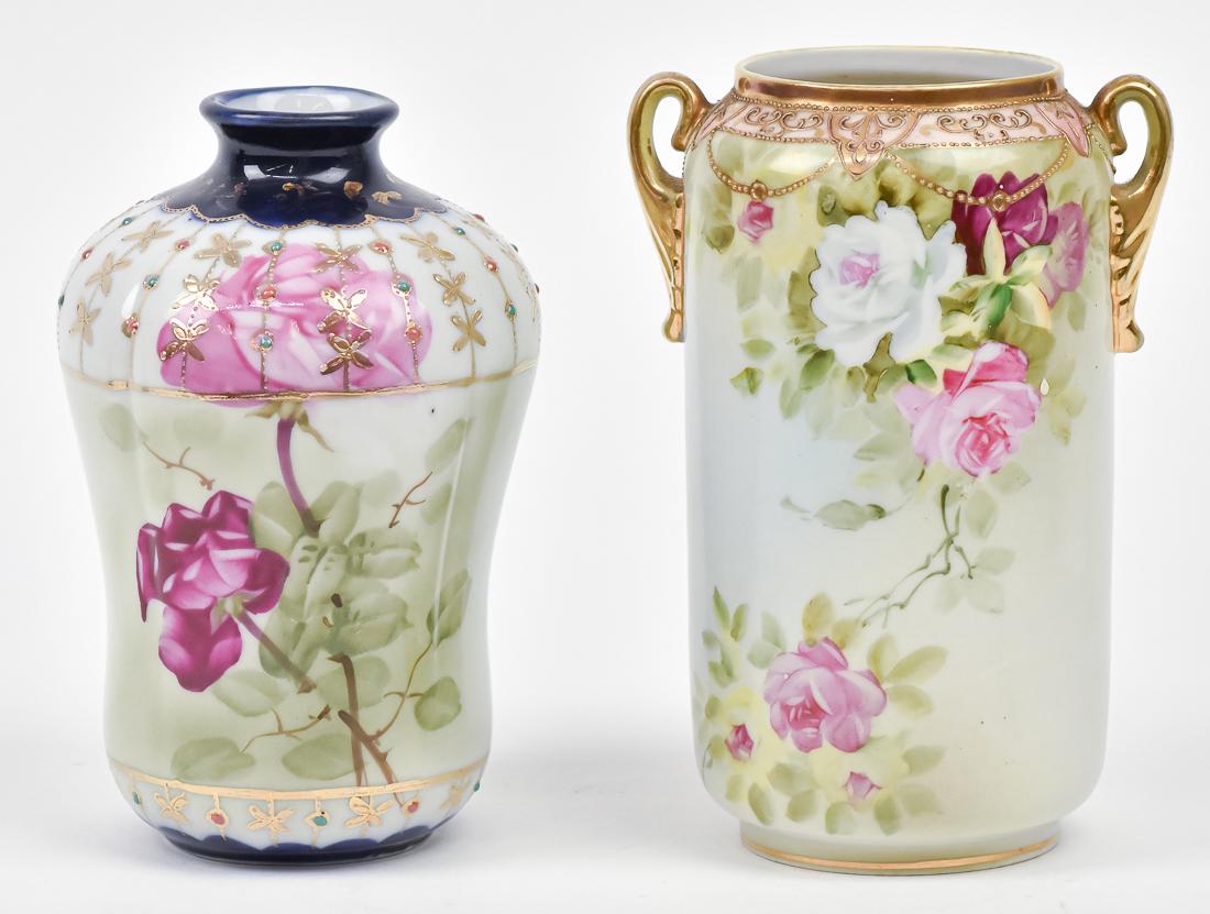 Two Nippon Vases: One 7" cobalt blue vase with jewels and illegible backstamp, and 7" double handled vase with floral decoration and maple leaf backstamp. Both good condition.
