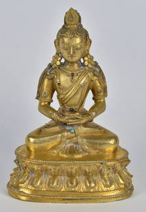 Tibetan Bronze Seated Buddah: 19th century seated in lotus position, atop lotus flower base, inset with gems, inscription on underside of base, 3 3/4 x 2 1/2 x 5 1/4" high. A few gems missing, otherwise fine condition.