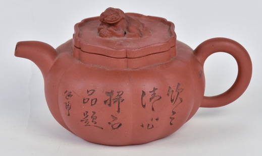 Fine Chinese Terra Cotta Yixing Teapot: Lotus pod form with C scroll handle and foo lion finial on lid. Two line Chinese inscription on left side and incised flowering tree branch on right side. Impressed Chinese mark on base, and two