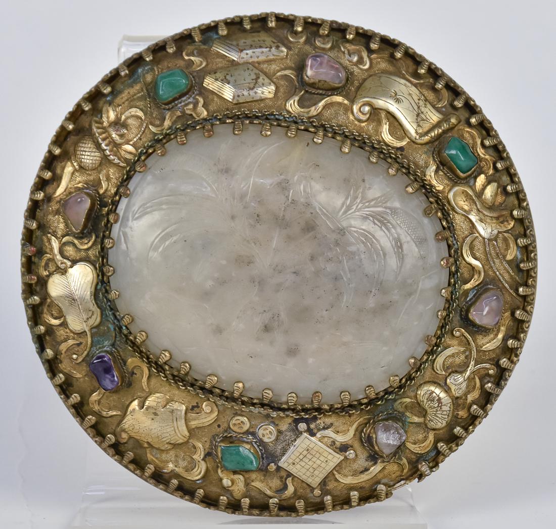 Chinese Jade & Silver Shield: Unmarked, but appears to be 19th century with large oval white jade gem in center with relief carved vase of flowers, mounted in chased silver mount with inset surrounding semi-precious stones, 5 1/8"