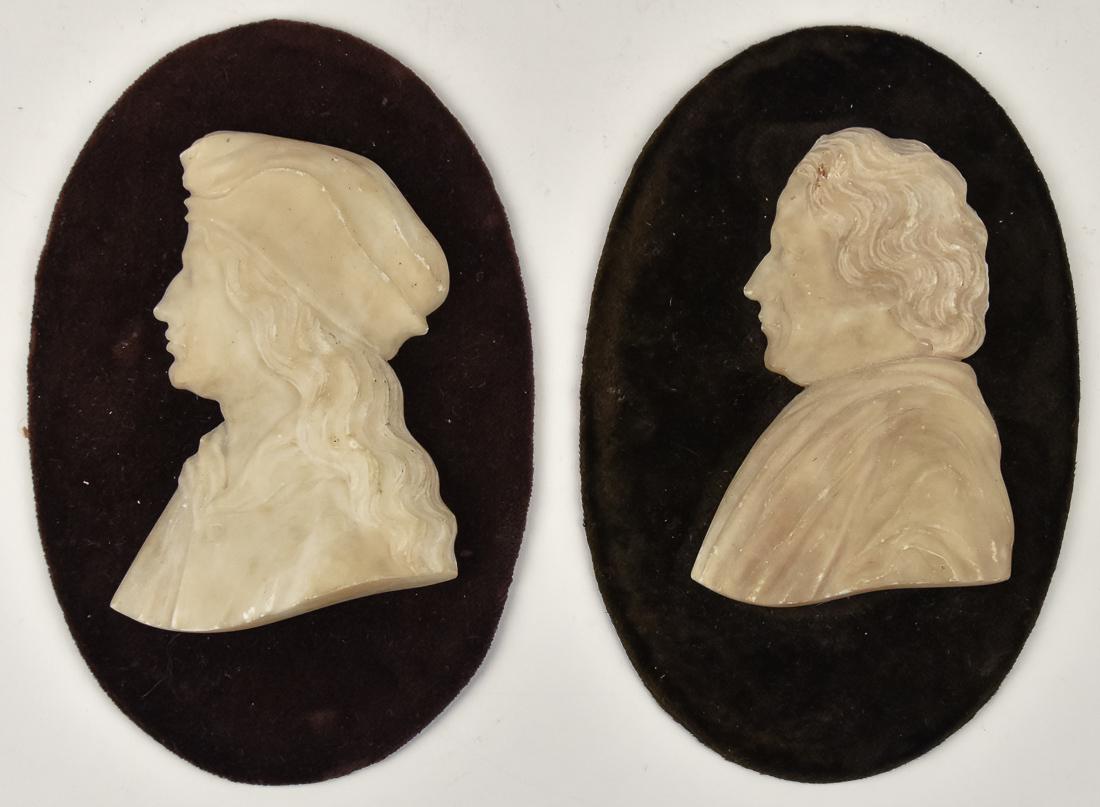 Pair of Sculptures: A pair of profile carved white marble portraits of gentlemen on oval flt covered mounts, with printed Italian labels on reverse, both 19th century, 4 1/4 x 6 1/2". Condition All Fine. The plaster head