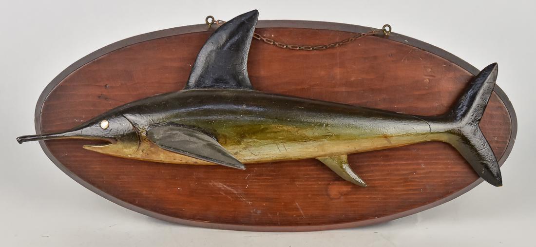 Folk Art Sail Fish Carving: Early 20th century, likely New England area full bodied carved wood in original polychrome painted finish with over varnish and MOP eye, mounted on oval pine board, 19 1/4 x 9" high. Condition Fine.