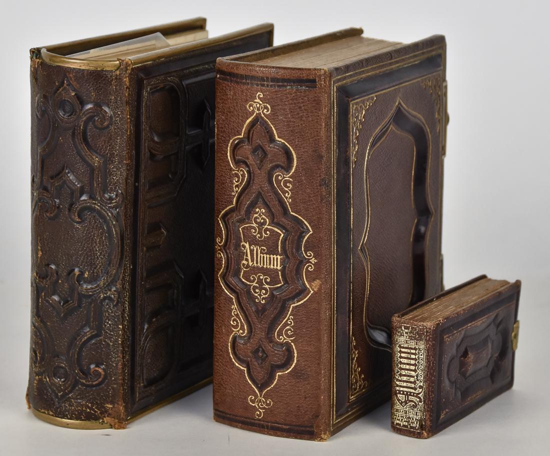 Three Early Photo Albums: All circa 1860's to 80's including two leather bound examples with brass clasps. The first has CDV sized photos, mainly albumen, most identified in period ink, some last names include Fuller, Lessner,