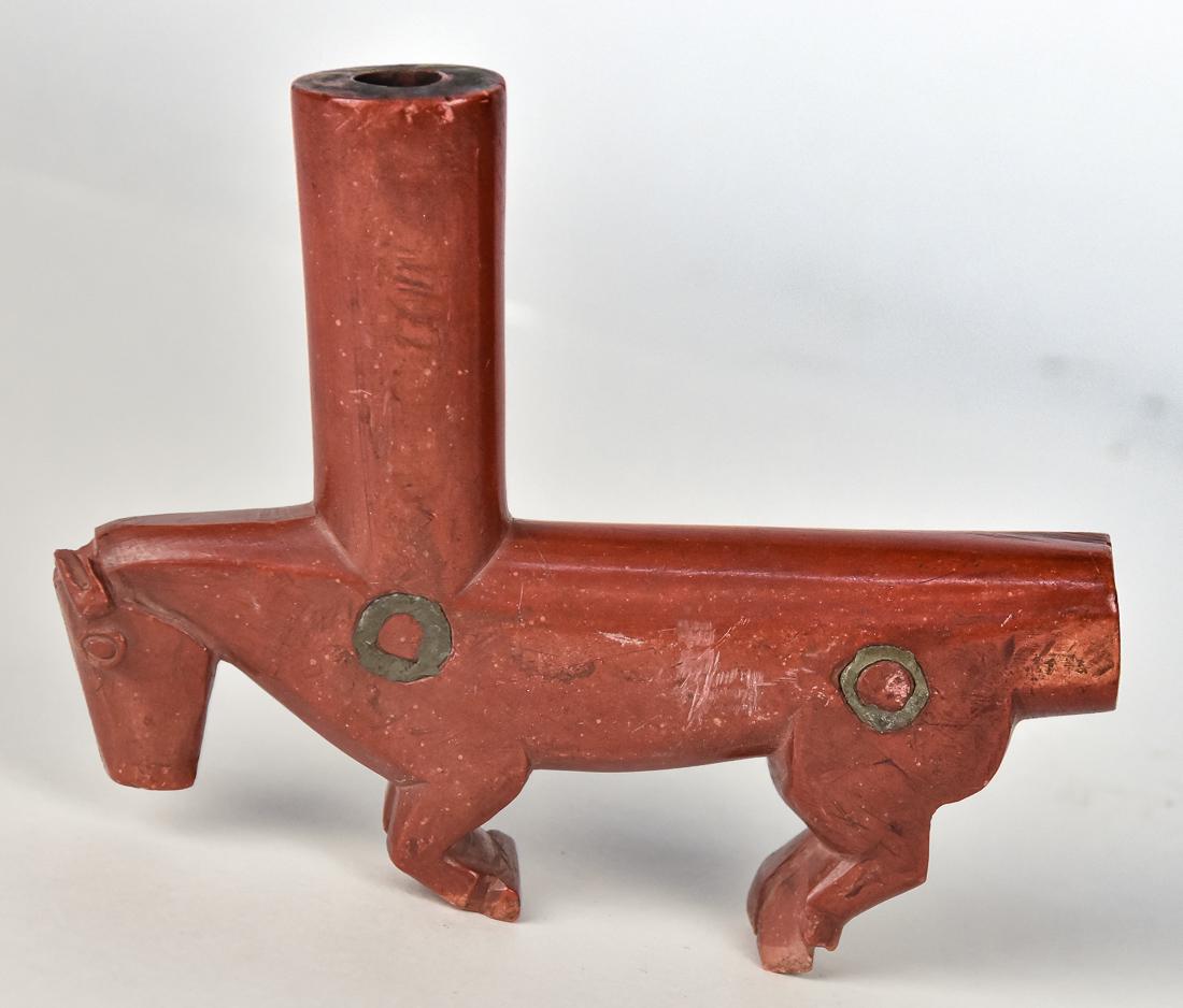 Plains Native American Figural Catlinite Pipe: Circa 1870, running horse with straight bowl from neck , two inlaid lead circles at shoulder and rump, nice old patina, 5 7/8 x 1 x 4 3/4" high. Condition chip on ears.