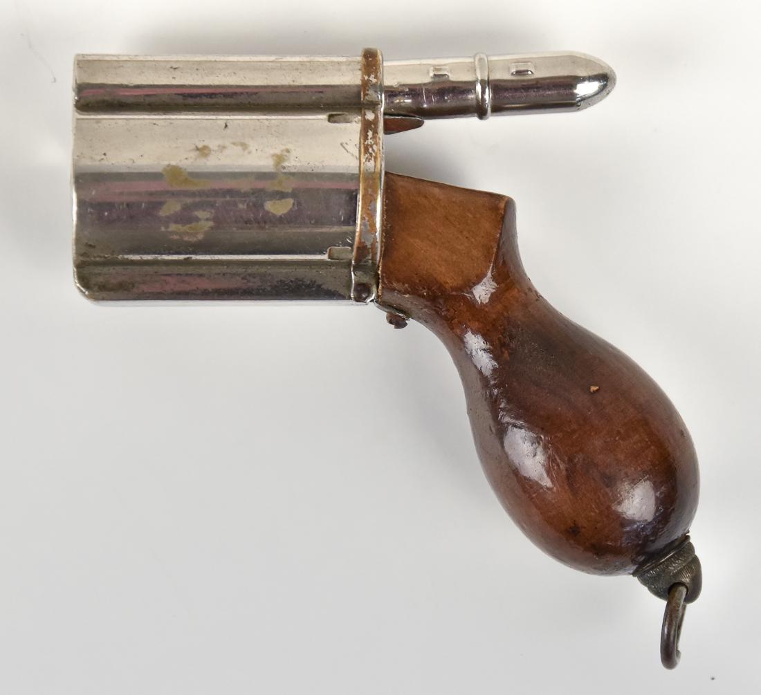 Unusual Revolver Form Dip Pen: Child's toy, but working dip ink pen in the form of a Derringer type revolver in nickeled brass with wood grip with ring langet. Bullet mounted in back o cylinder isretractable and is a dip ink pen, 3