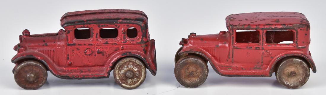 Arcade & Other Ford Sedan Toy: Both cast iron in original red painted finish, Arcade marked Freeport Ill. On underside with stamped steel wheels, 4 x 1 1/2 x 2" high; and example with cast iron wheels with pedal pattern hubs and re