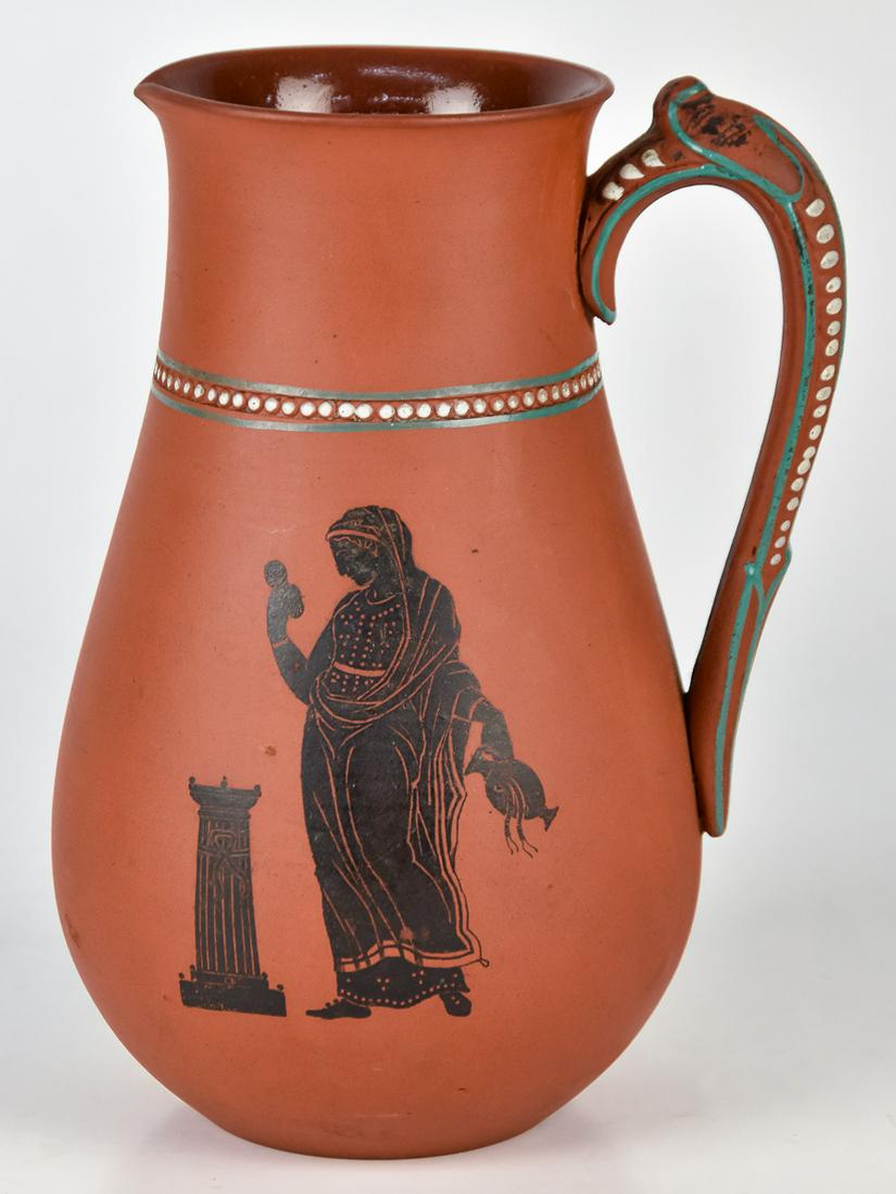 W.H. Goss Red Stoneware Pitcher: English circa 1860's, decorated with black figures in the Greek style with C scroll handle and enameled beading, marked on base, 7 3/8" high. Condition Fine.