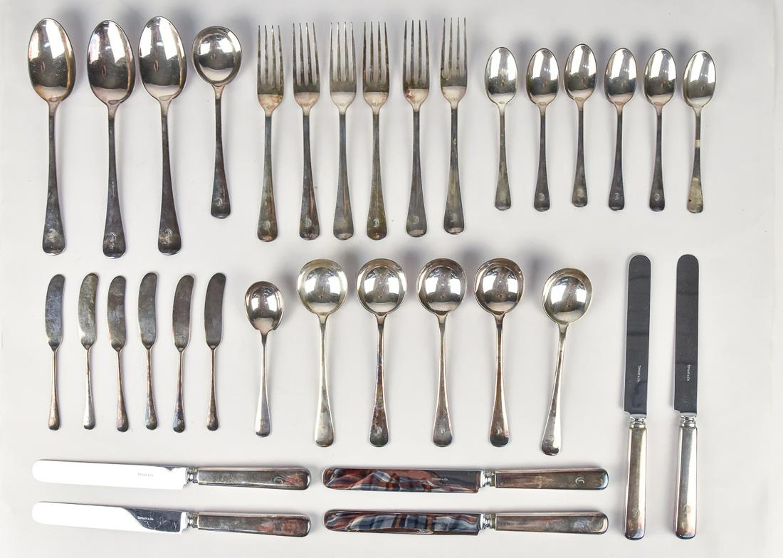 Tiffany Silver Plated Flatware: Early 20th century, service for six with dinner forks, tea spoons, soup spoons, dinner knives, butter knives, three serving spoons and one sugar spoon, all in original felt cases with Tiffany labels.