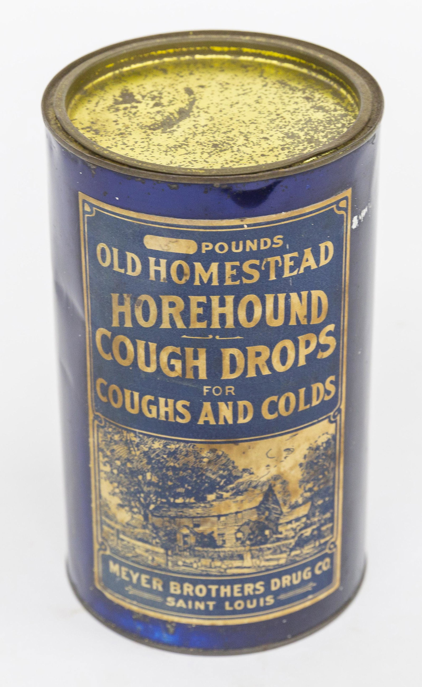 Horehound Cough Drops Tin Can: Blue lacquered tin with lithographed illustrated label showing farmstead with figures in blue, text reading; Pounds/Old Homestead .Horehound/Cough Drops/For/Coughs And Colds/Meyer Brothers Drug Co./Sa