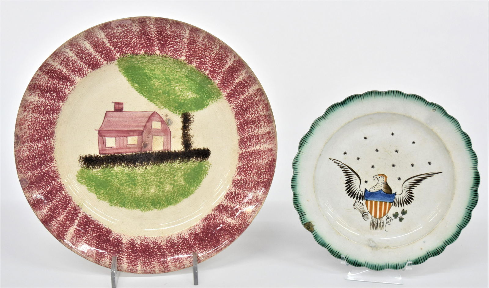 Spatterware & Feather Edge Plates: Lot of two including a spatterware plate with schoolhouse pattern in red, green & brown, 10 1/2" diameter; and polychrome painted U.S. shield breaded spread winged eagle, clutching arrows and laurel b