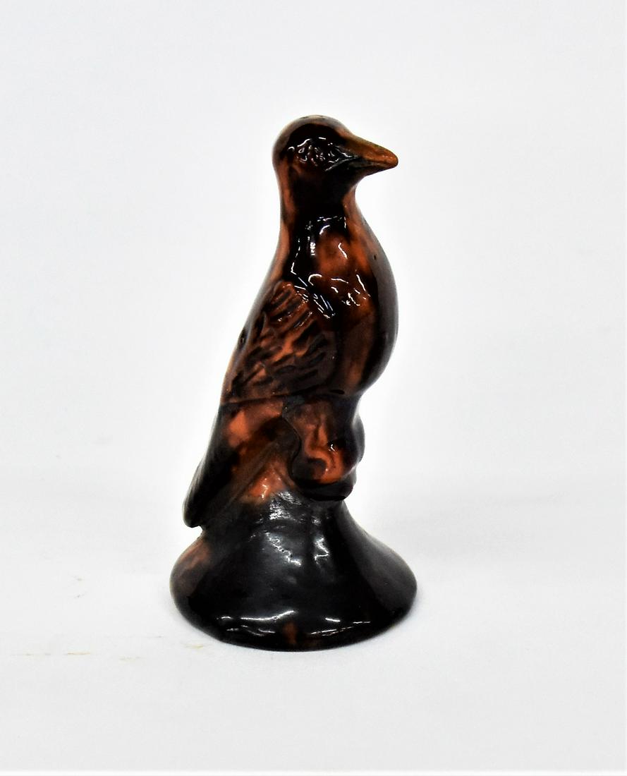 Early Penn. Redware Bird Figure: Circa 1860-80, hand molded perching bird on cone in mottled Rockingham type glaze, unsigned, 2 1/4" diameter x 4 1/2" high. Condition repair to beak, else Fine.