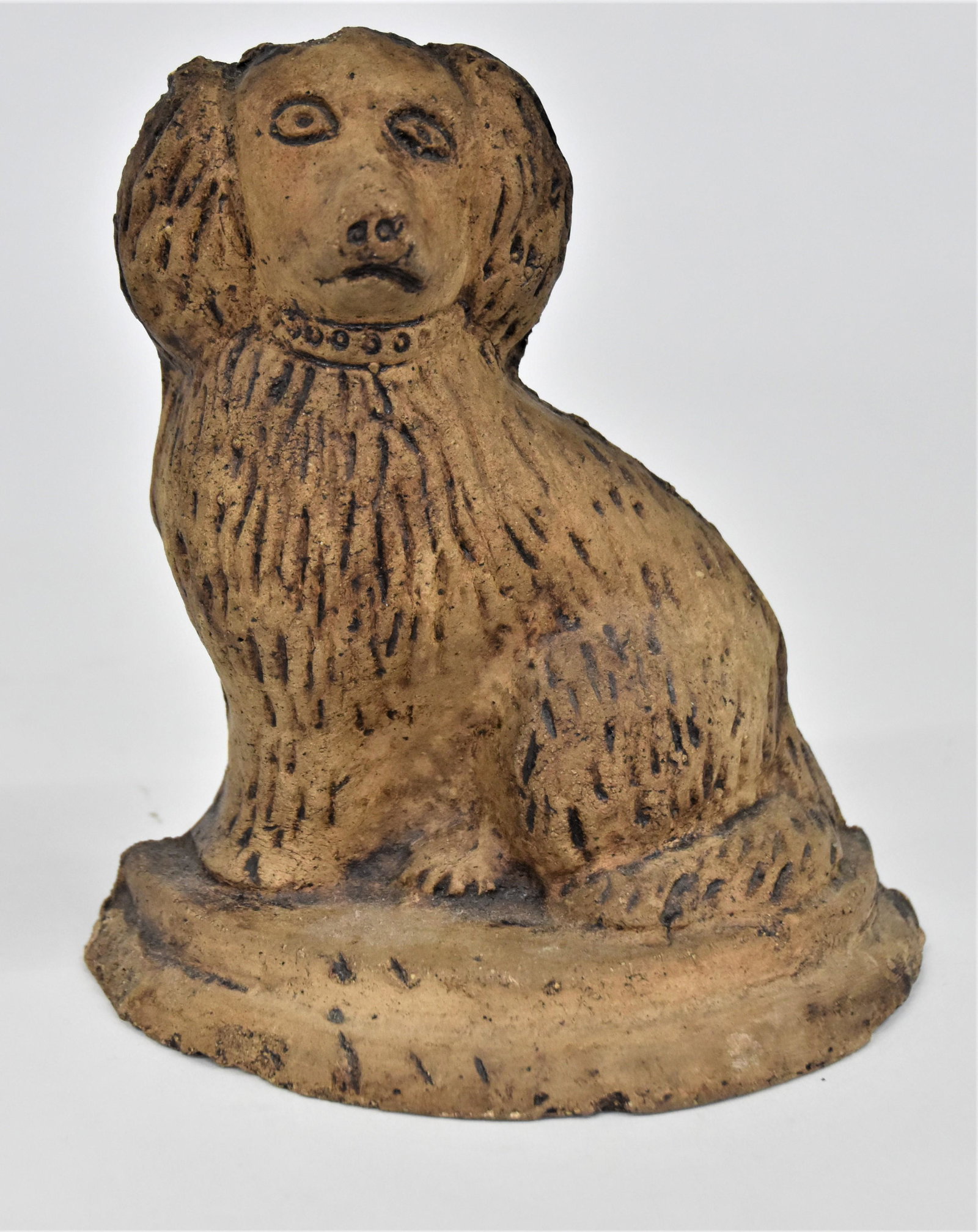 Stoneware Spaniel Doorstop: Molded with half round base, 6 1/2 x 3 x 7" high. Condition small flake on top of head, else Fine.