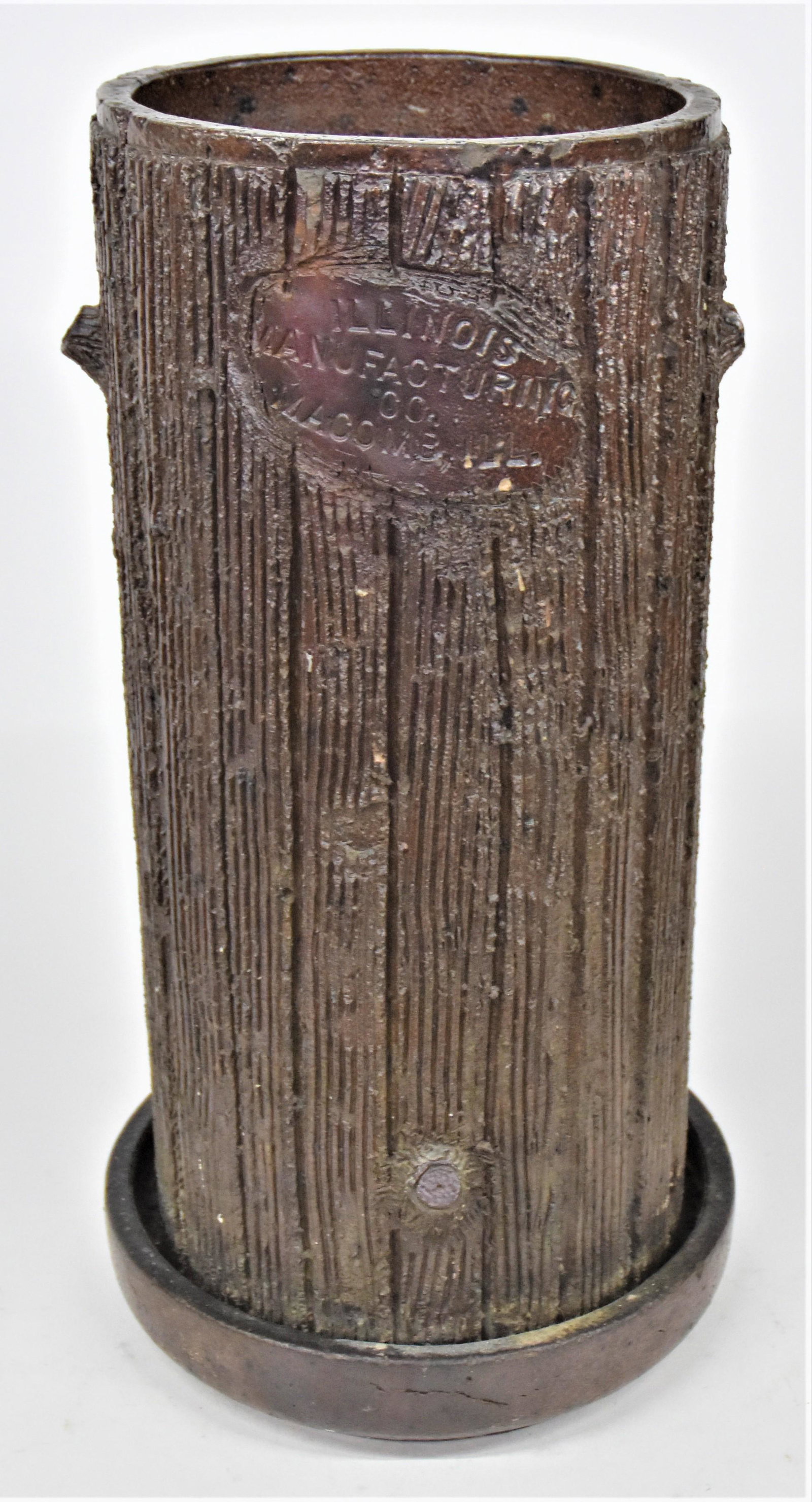 Sewer Tile Umbrella Stand: Tree trunk from with trimmed branch knots, oval escutcheon with Illinois/Manufacturing/Co./Macomb, Ill., 11" diameter x 21 1/2" high. Condition one minor flake at lip, else Fine.