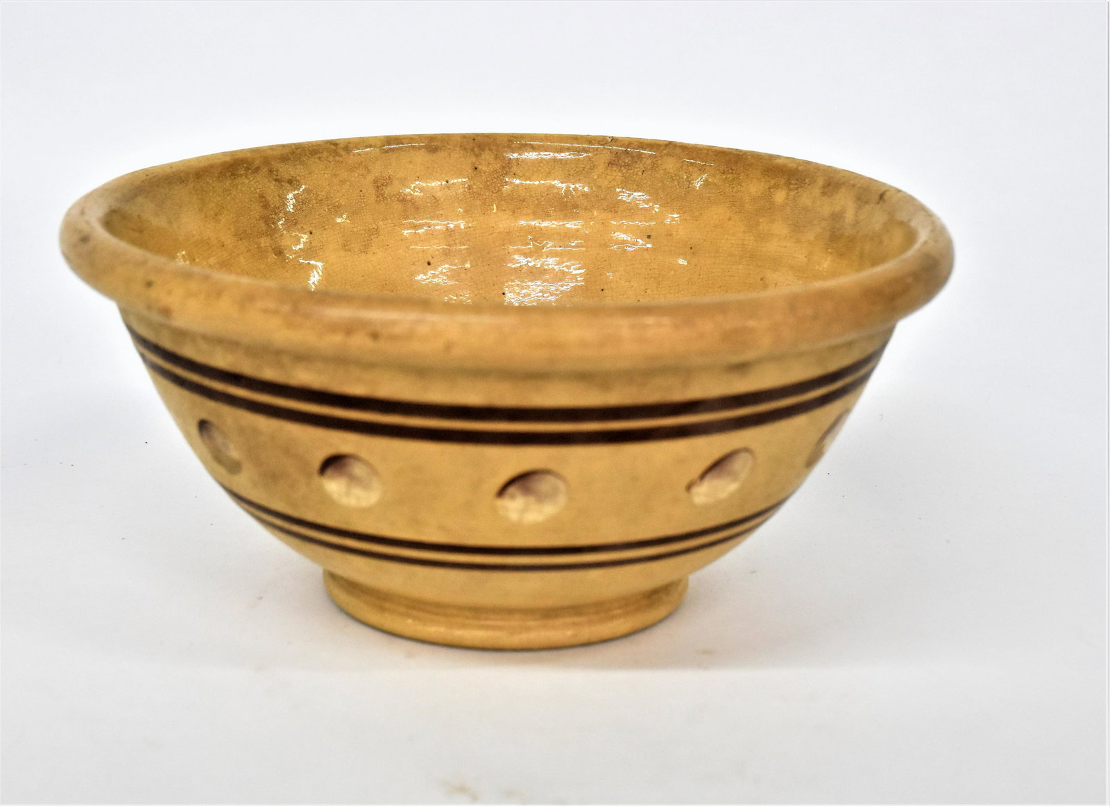 East Liverpool Ohio Decorated Yelloware Bowl: Attributed, unsigned, found in Adams County, circa 1850-60, thickened lip and foot with slip trailed brown and white cats eye decoration, bordered by paired brown annular bands, 10 1/2" diameter x 4 3