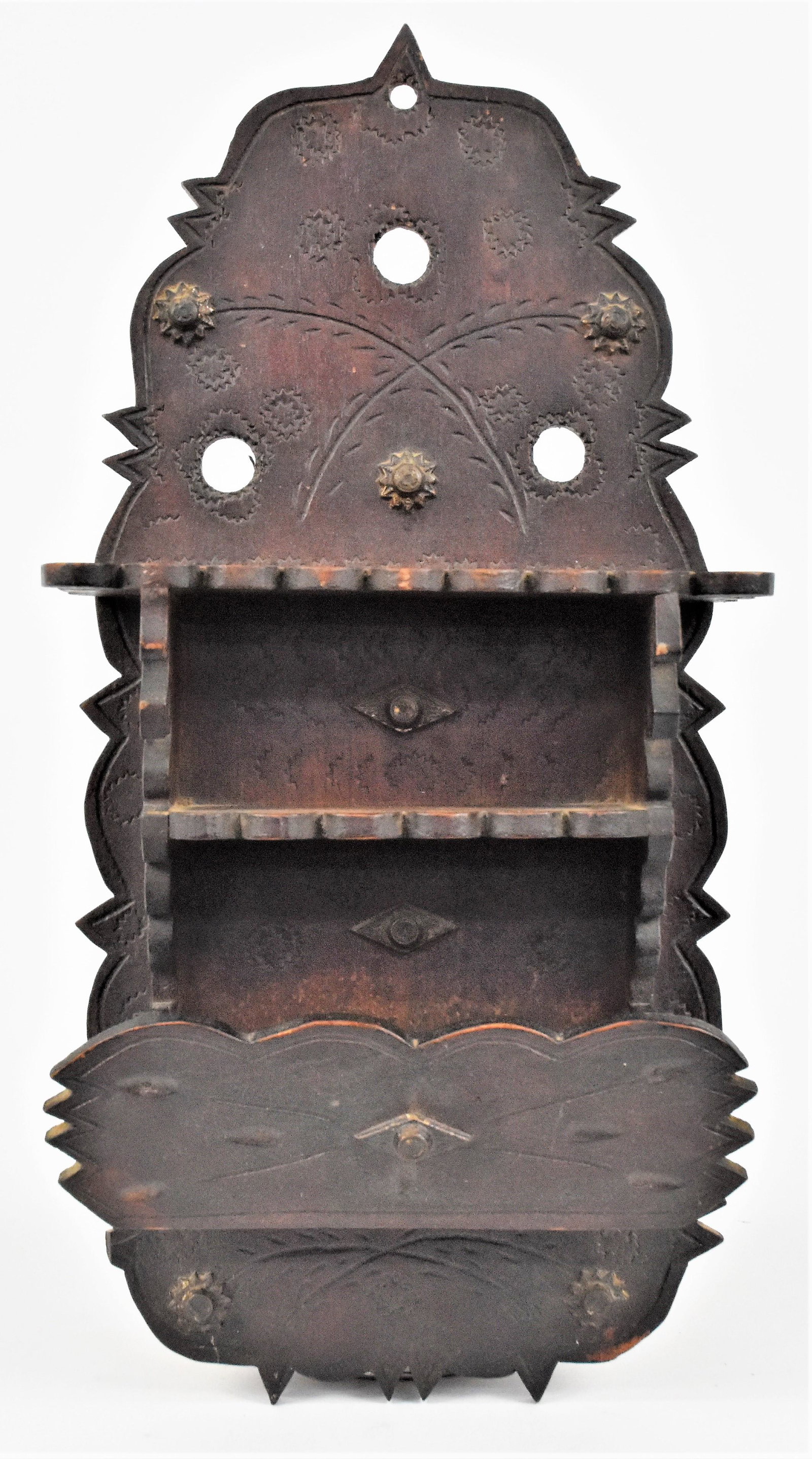Folk Art Wall Shelf: Chip carved and scroll cut in original old red painted finish with stamped rosettes and applied rosettes, circa 1880 in pine, 9 x 3 1/2 x 18 1/2" high.