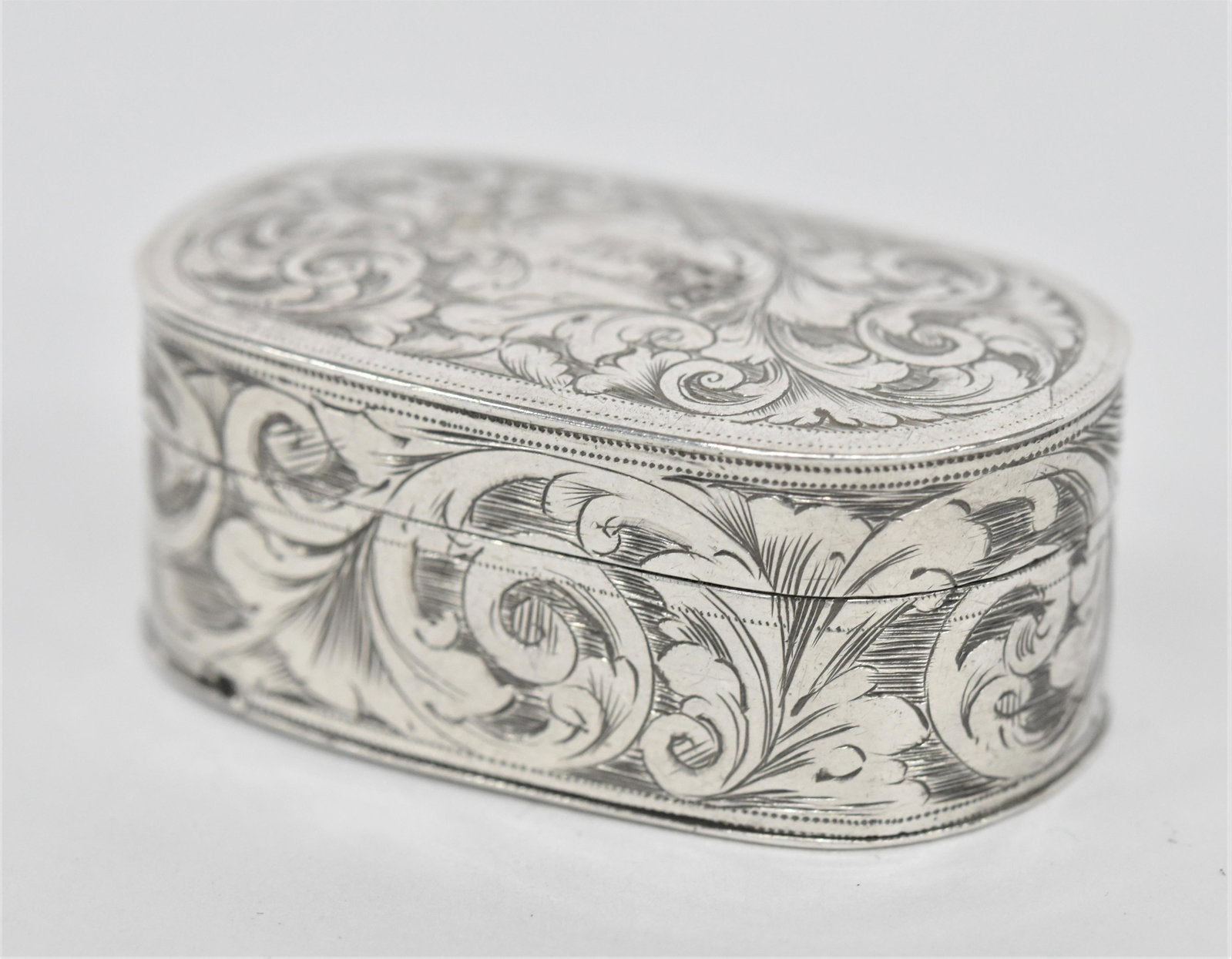 1835 London Sterling Silver Vinaigrette: Oval with all over engraved floral scroll with hinged lid with escutcheon engraved entwined HH over Roseland, London hallmarks on lid and base with markers mark of PP&ER, interior with punched steel p