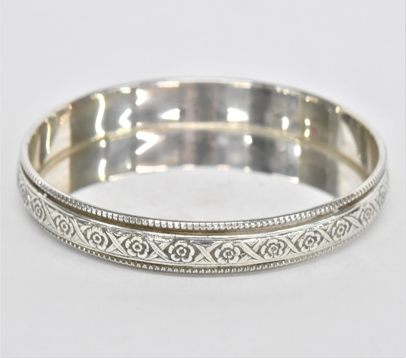 Sterling Wine Coaster: Bottle coast marked Sterling with chased and beaded edge, engraved on interior wall A.S.G. W.O.B. July 29, 1956, 4 1/4" diameter x 5/8" high, total weight 2.70 ozt. Not on base reads W.O.B. was an arc