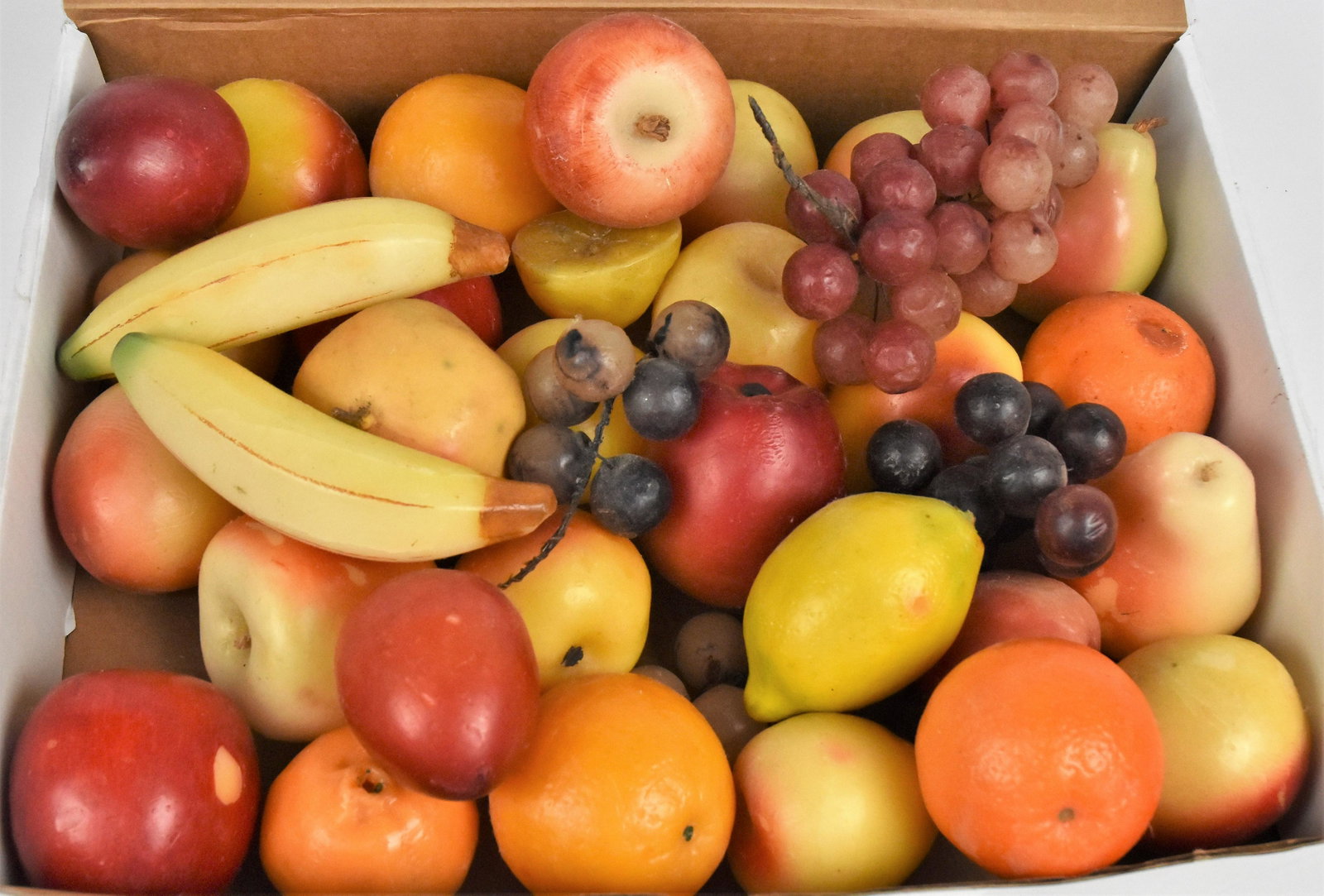 Large Group Wax Fruit: Mid 20th century, 35 piece including variety of apples, oranges, bananas,pomegranate, grapes, lemon, plum, pears and scarce cut lemon, bananas id 6" long. Condition Fine to Very Good.
