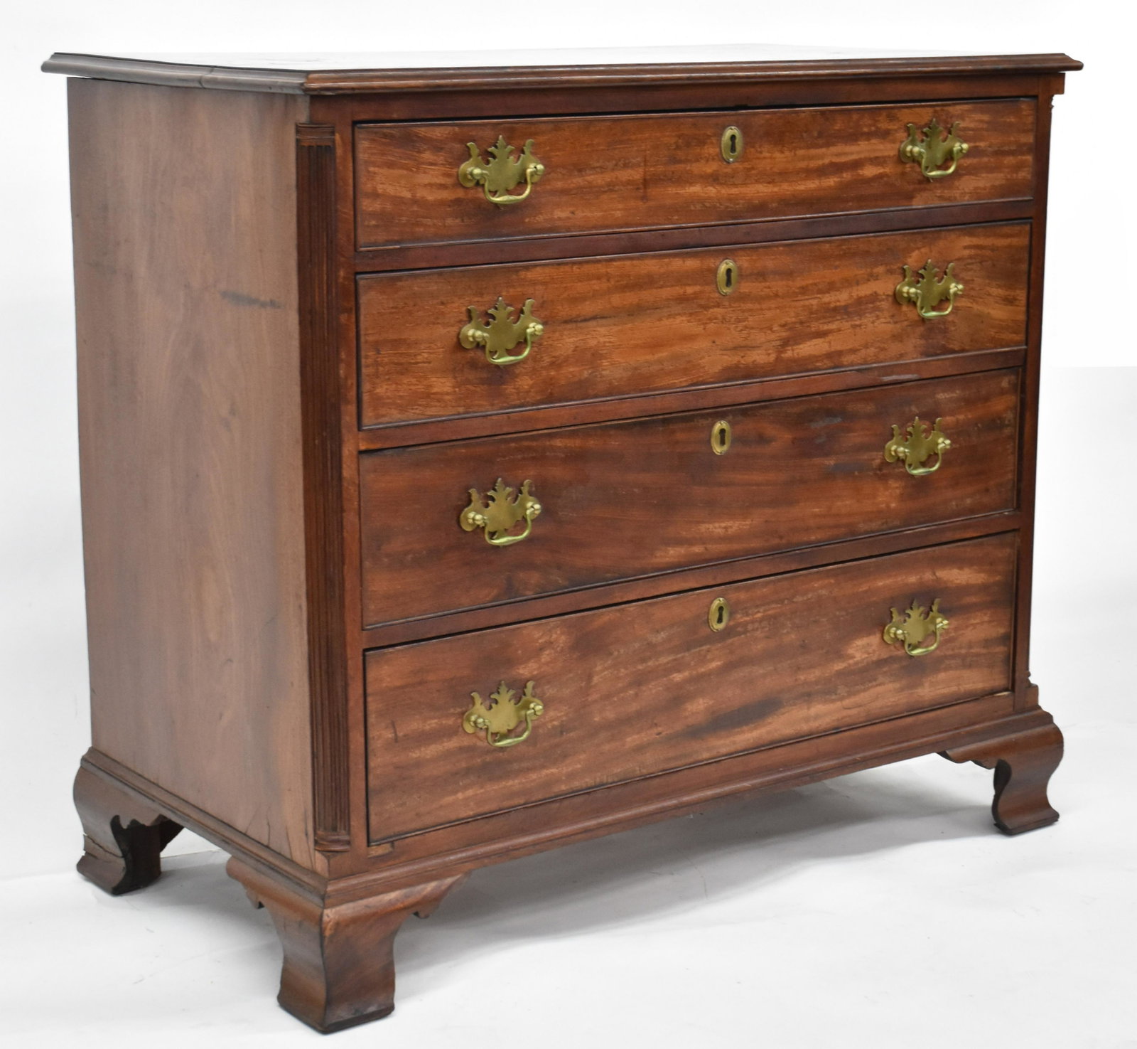 Period Penn. Chippendale Chest: Circa 1780-90 in mahogany with thumb molded top, over four dovetailed graduated drawers with cock beaded edging and brass bat-wing bale pulls, fluted quarter columns, solid ends, fine original ogee br