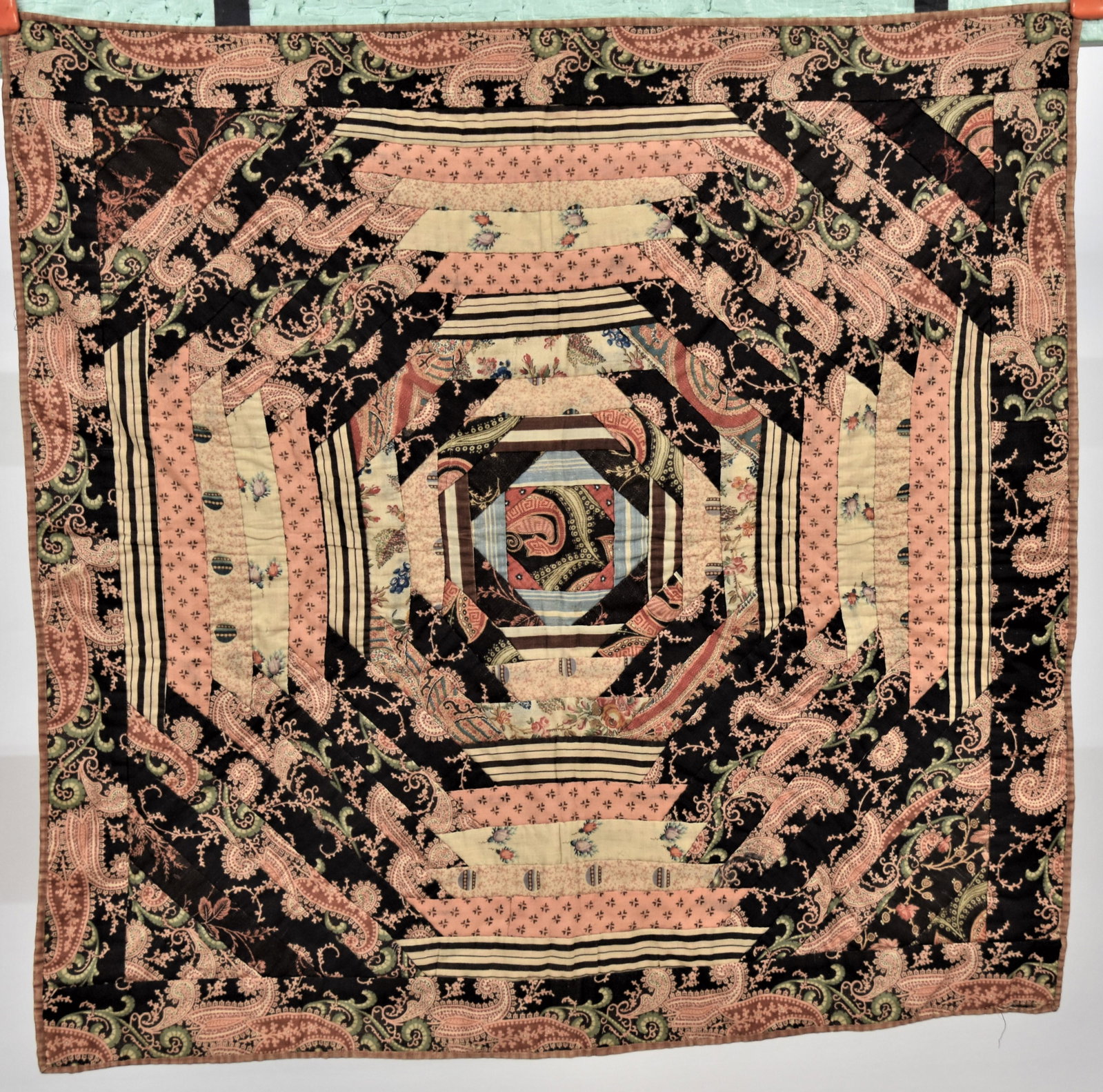 Early Crib Quilt: Circa 1860, early polychrome printed paisley fabrics with calico printed backing, 28" square. Condition Fine.
