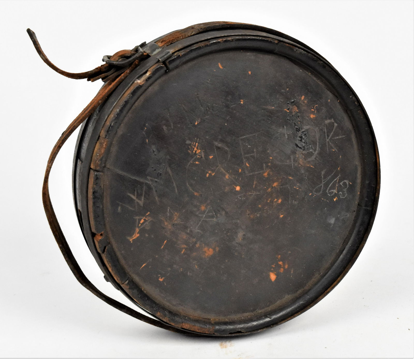 Captured Confederate Canteen: Wood drum form with wrought iron bands and leather shoulder strap, one face has carved name and date of Wm. Gregor-/y May 17 1863 with smaller carved name above of J. Magill, fine dark patina; 7 1/2"