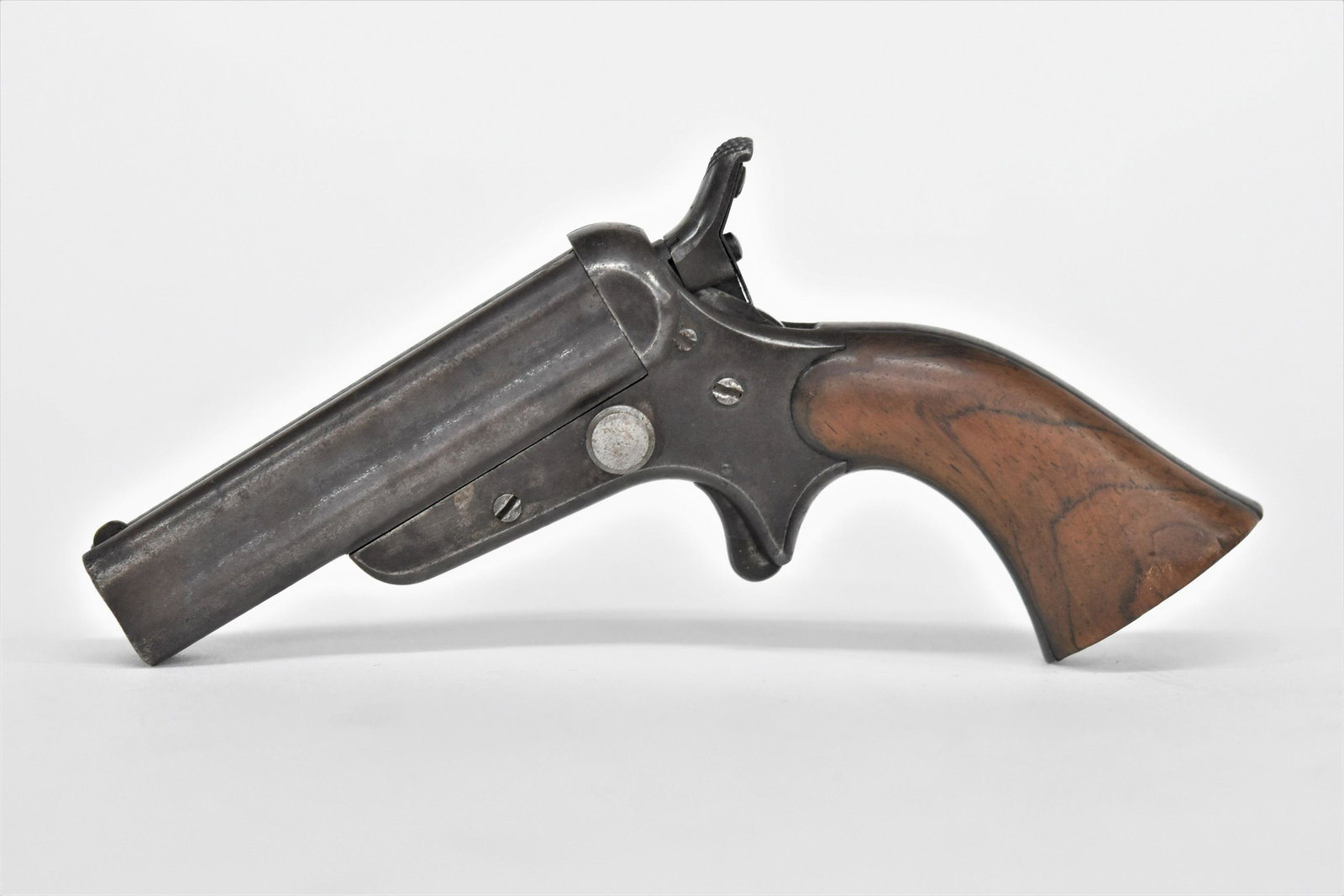 Sharps & Hankins Tip-Up Pistol: Four shot with 3 1/2" long barrel marked; Address Sharps & Hankins Philadelphia Penn. And marked on right side of receiver Patent 1859; circa .32 caliber with fine walnut grips, nice brown patina, 6" 