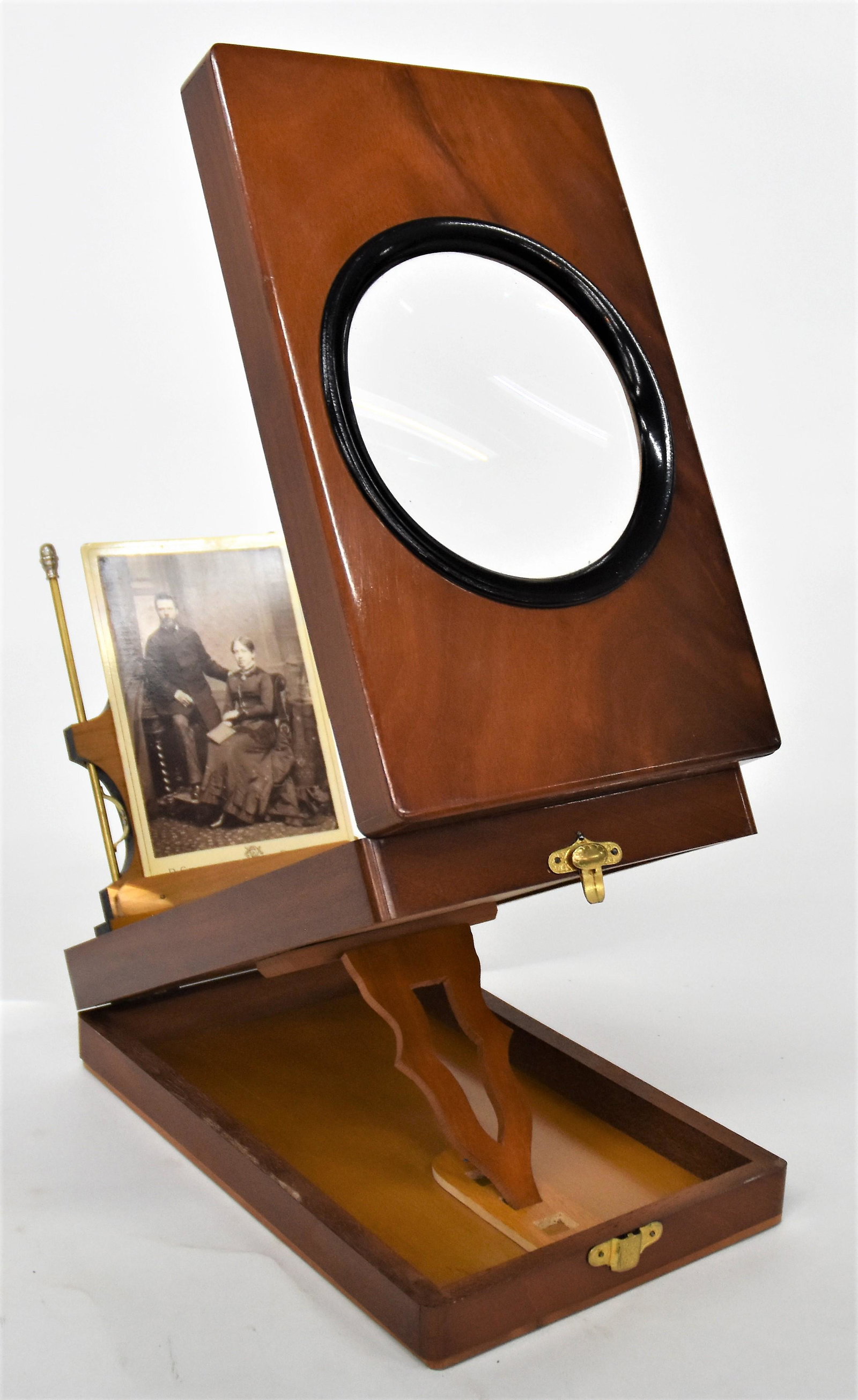 Cabinet Card Viewer in Original Box: Mahogany with ebonized ring at magnifying glass, satin wood interior, brass mounts, 10 5/8 x 6 58 x 3 1/8" high, closed in original textured card stock box. Condition Viewer is mint, unused, box has s