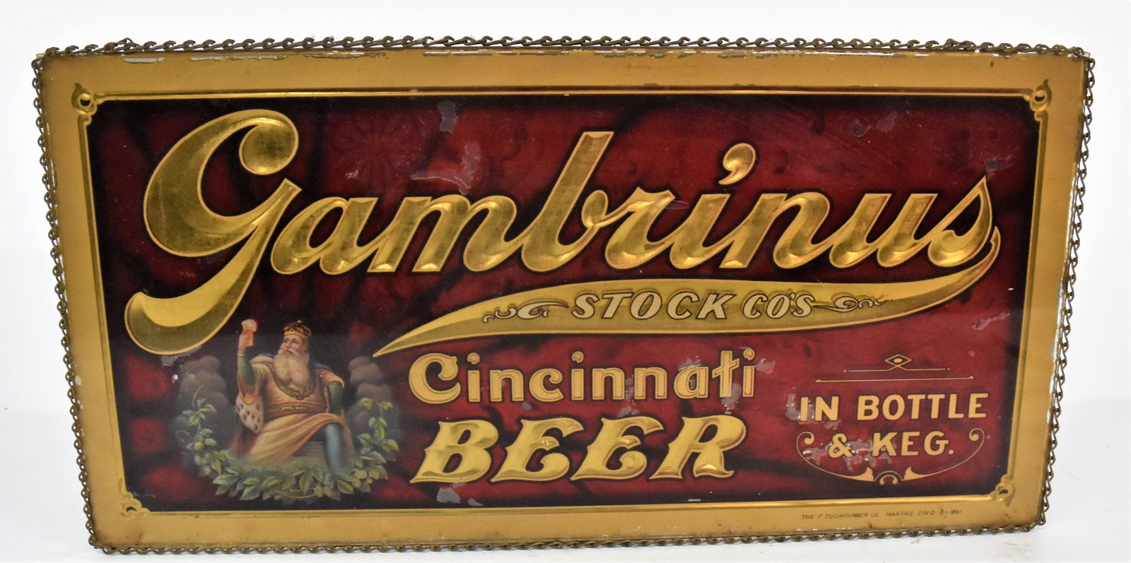 Gambrinus Reverse Painted Beer Sign: Chromolithographed with figure of Gambrinus seated on thrown holding glass of beer with laurel wreath surround and Gilt Gambrinus Stock Co. Cincinnati Beer In Bottle & Keg., with original brass chain 