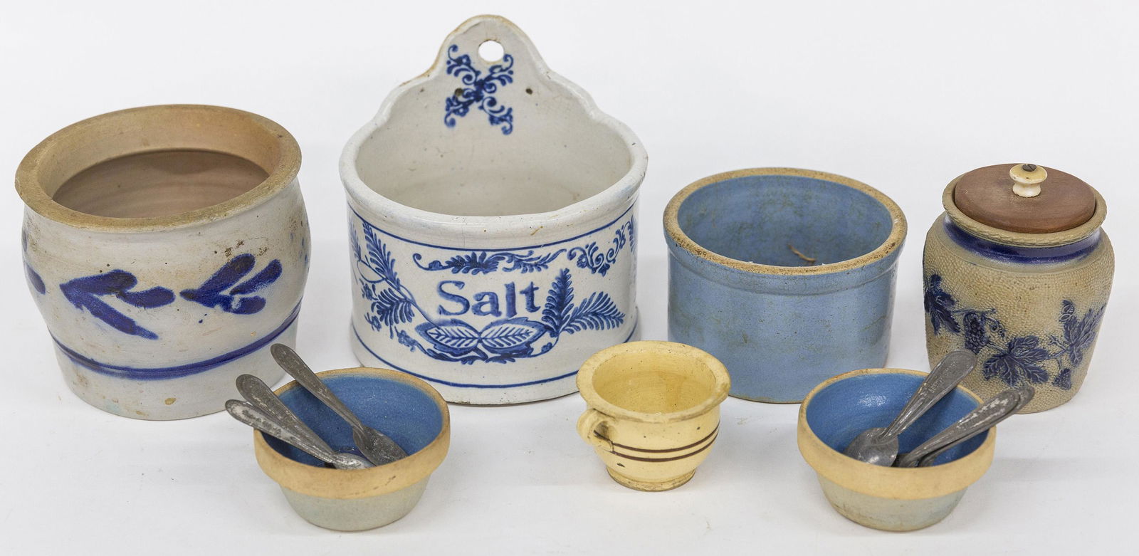 Six Pieces of Stoneware Plus: Including a salt glaze honey jar with molded maple leaves in cobalt and cobalt band at neck with tuned wood lid3 1/2 x 3 3/4" high, less lid; plus ovoid open jar with free hand cobalt decoration, slig