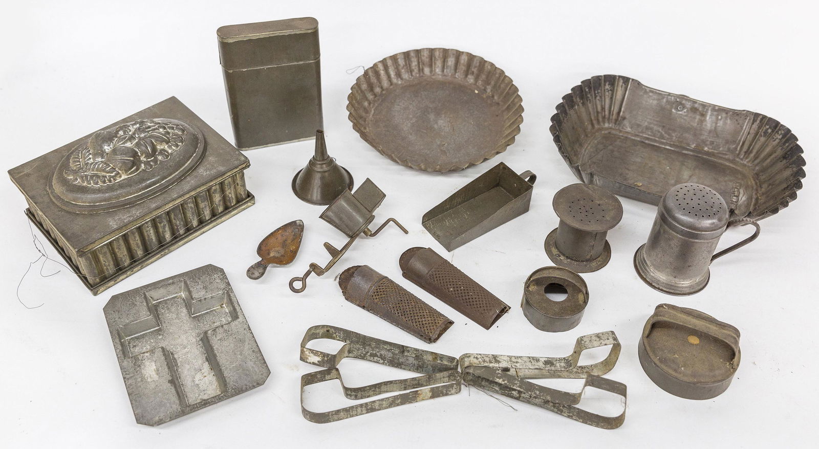Large Lot of Tinware: Lot of 20, including trays, sander, cookie cutters, muffineer; fluted pie plate; nutmeg graters; pudding mold and more. Condition Fine to Very Good.