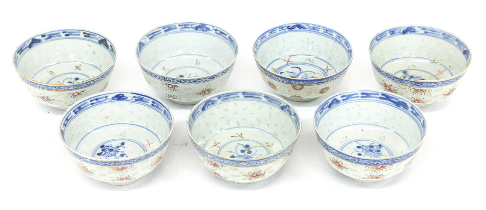 Japanese Porcelain Rice Bowls: Set of seven, blue underglaze stylized floral and gilt and red overglaze Japanese characters, blue underglaze marks on base in Japanese characters, 4 1/2" diameter x 2 1/2" high. Condition 2 with tiny