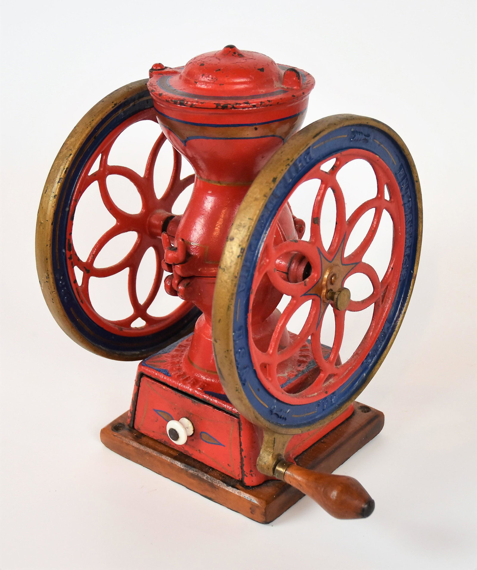 Enterprise Coffee Mill: Small cast iron & wood counter top mill with wheels marked Enterprise MFG. Co. Philadelphia U.S.A. with wood grip on handle, iron drawer and wood base, domed lid on hopper, in original polychrome pain