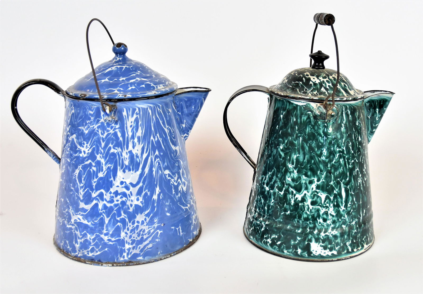 Two Granite Ware Coffee Pots: Including a nice drk green example with domed lid C scroll hsndle, wire swing bale hsndle with turned wood grip, turned knob finil, 12 x 8 5/8 x 12" high, less bale; and blue example with C scroll han