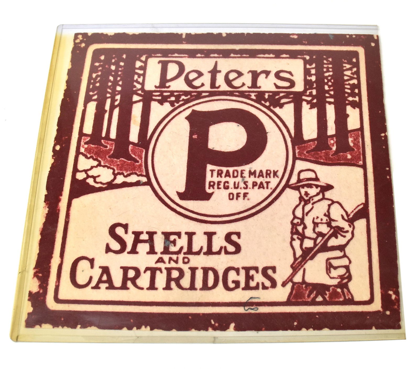 Peters Cartridge Advertising Felt: Red on white with forest scene with hunter and Peters, over P inside circle, over Shells/And/Cartridges, 11" square. Condition, moth damage at edges, still Very Good.